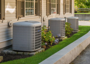 Three exterior air conditioning units outside of a Texas office building