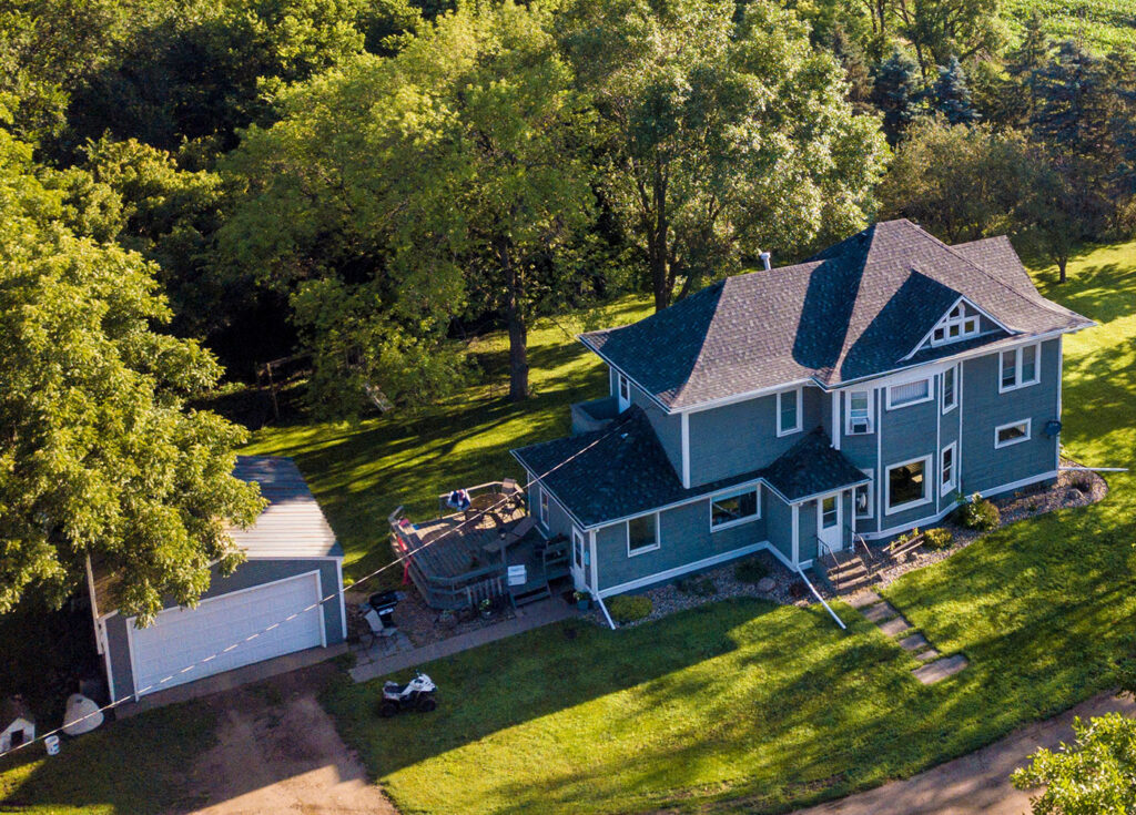 Arial view of a blue South Dakota house and detached garage.