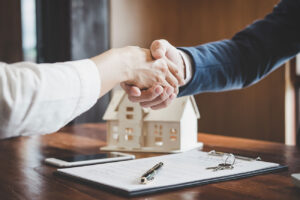 Texas Real Estate Agents shaking hands after closing on a property.