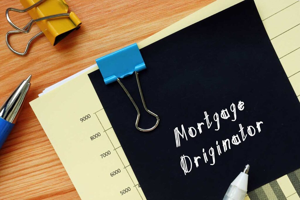 Desk with pens and paper that says Mortgage Originator