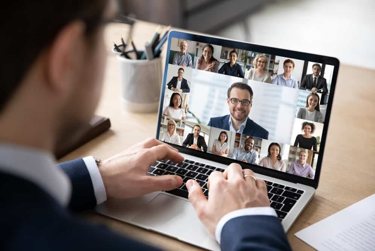 Man in a virtual meeting on laptop