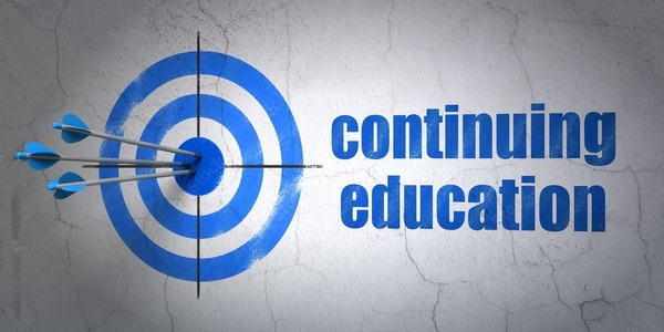 Learning concept: target and Continuing Education on wall background
