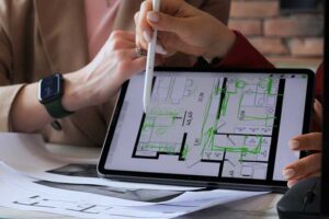 Two architects reviewing house plans on a tablet