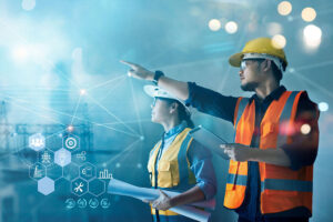 Male and female engineers pointing into distance