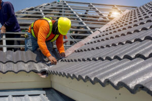 Roofing contractor working on roof