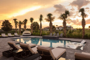 A pool in Florida sunset with palm trees